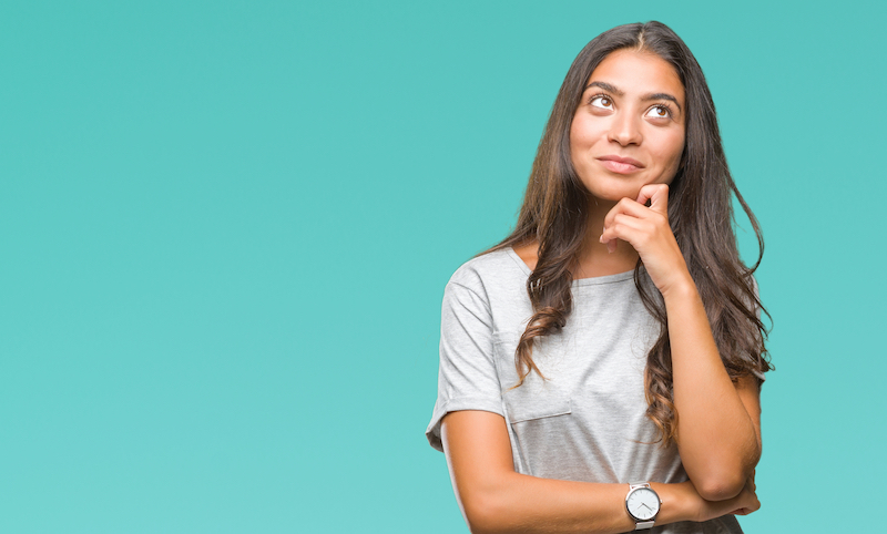 Woman over isolated blue background thinking