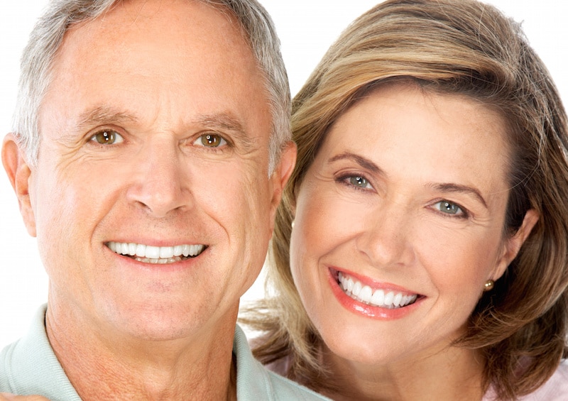 Smiling older couple with nice teeth and strong jaws due to permanent dentures
