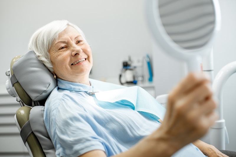 Woman with implant-supported denture