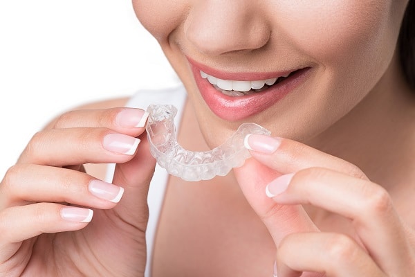 woman with Invisalign tray