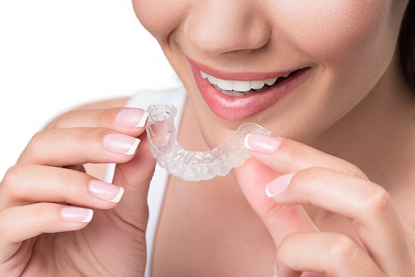 woman with Invisalign tray