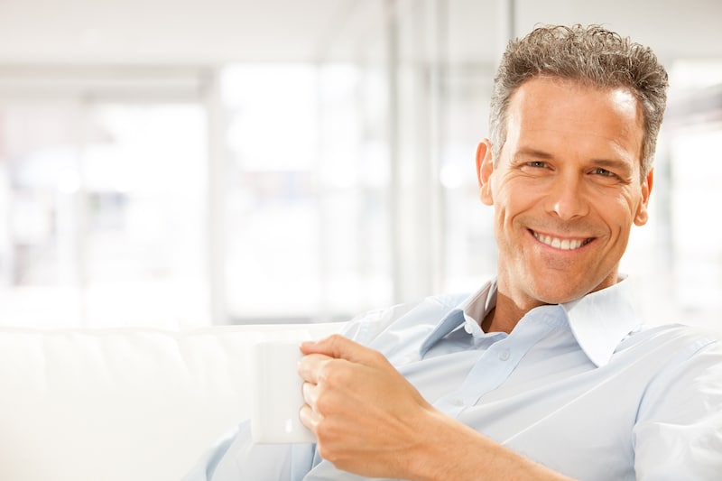Middle aged man relaxing after dental implant recovery | Las Vegas Cosmetic Dentist Dr. Jorge Paez