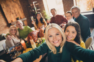 cheerful big full family grandparents parents brother sister gathering having fun celebratory