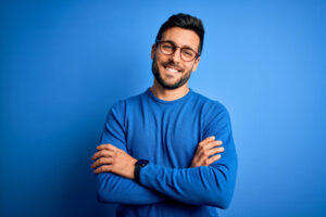 handsome man with beard wearing casual sweater and glasses