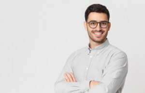 handsome businessman wearing gray shirt and glasses, holding arms crossed