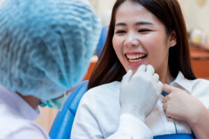Happy dental patient after getting root canal with dental crowns